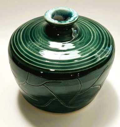 White clay body with unique etchings and linear detailing. Emerald green glaze exterior. White glaze interior. H-4.5in x W-5in.